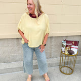 Golden yellow short sleeve blouse with a relaxed fit and dolman sleeves, styled for casual or dressy occasions.
