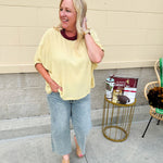 Golden yellow short sleeve blouse with a relaxed fit and dolman sleeves, styled for casual or dressy occasions.