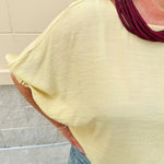 Golden yellow short sleeve blouse with a relaxed fit and dolman sleeves, styled for casual or dressy occasions.
