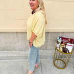 Golden yellow short sleeve blouse with a relaxed fit and dolman sleeves, styled for casual or dressy occasions.