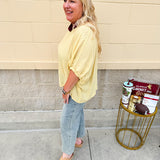 Golden yellow short sleeve blouse with a relaxed fit and dolman sleeves, styled for casual or dressy occasions.