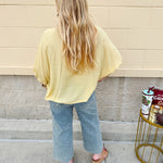 Golden yellow short sleeve blouse with a relaxed fit and dolman sleeves, styled for casual or dressy occasions.