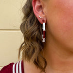 Garnet and white striped enamel hoop earrings with gold trim