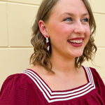 Garnet and white striped enamel hoop earrings with gold trim