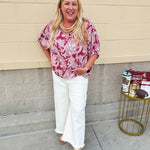 Lightweight garnet top with white paisley print, boat neckline, and loose dolman sleeves.