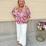 Lightweight garnet top with white paisley print, boat neckline, and loose dolman sleeves.