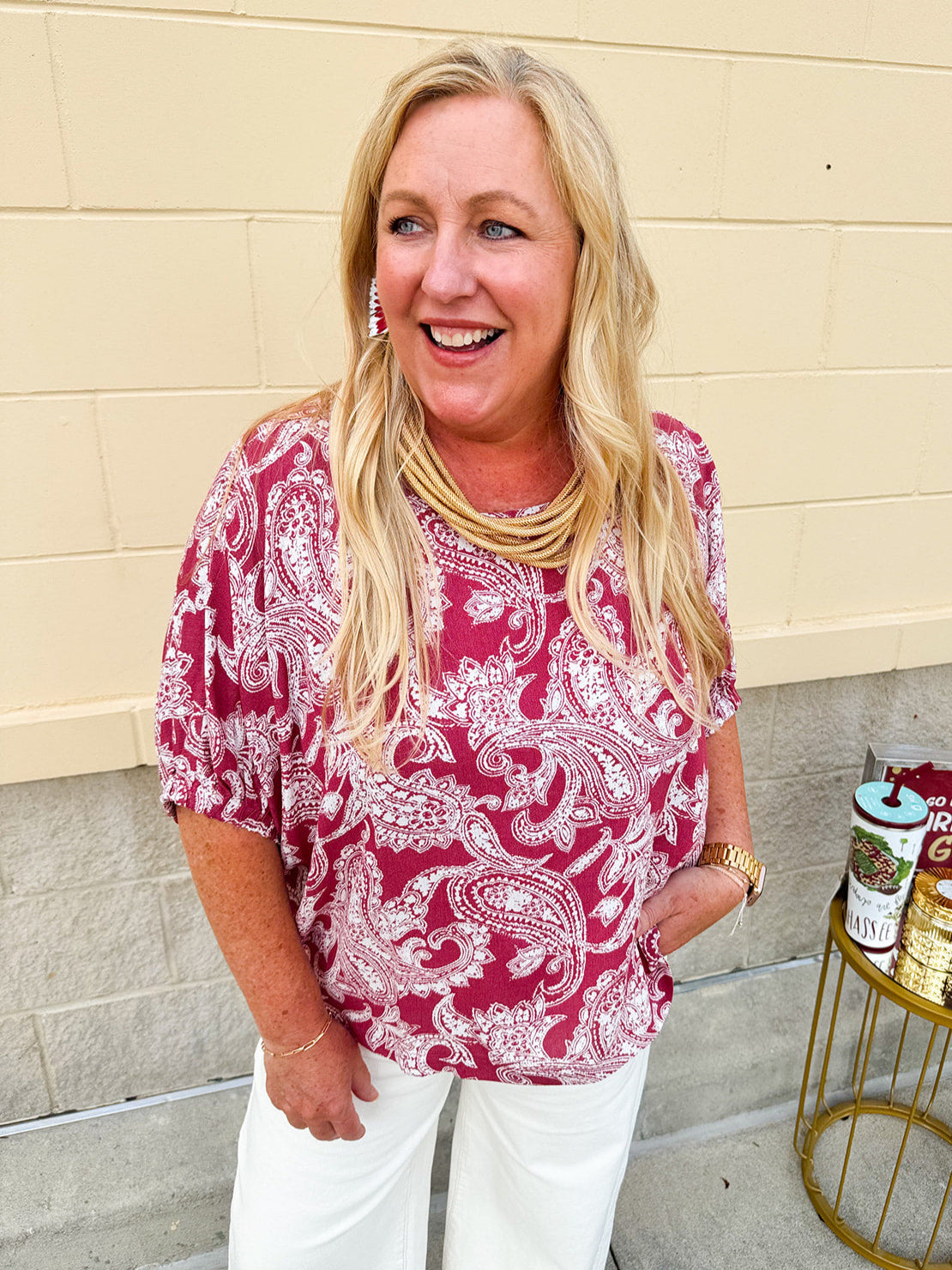 Lightweight garnet top with white paisley print, boat neckline, and loose dolman sleeves.