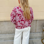 Lightweight garnet top with white paisley print, boat neckline, and loose dolman sleeves.