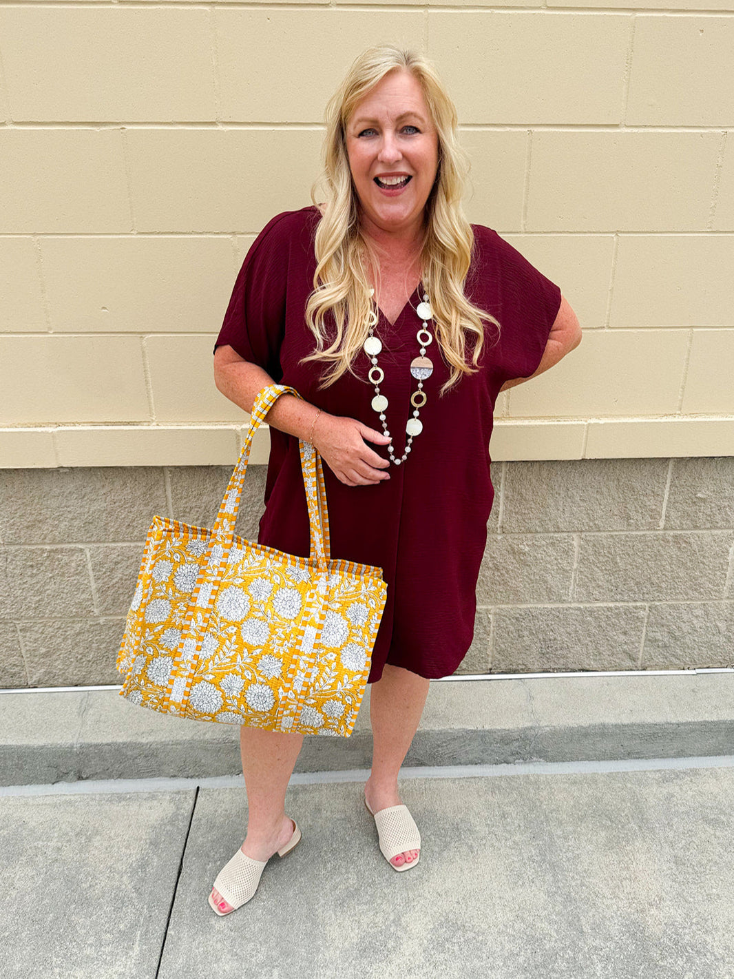 Garnet short sleeve mini dress with deep V-neck, drop shoulders, and side pockets—perfect for gameday.