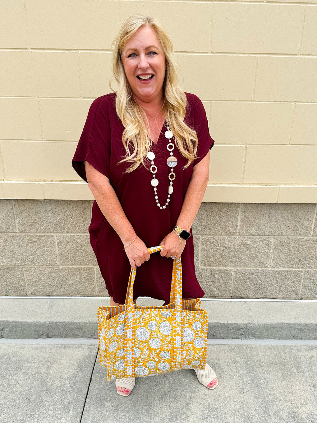 Garnet short sleeve mini dress with deep V-neck, drop shoulders, and side pockets—perfect for gameday.