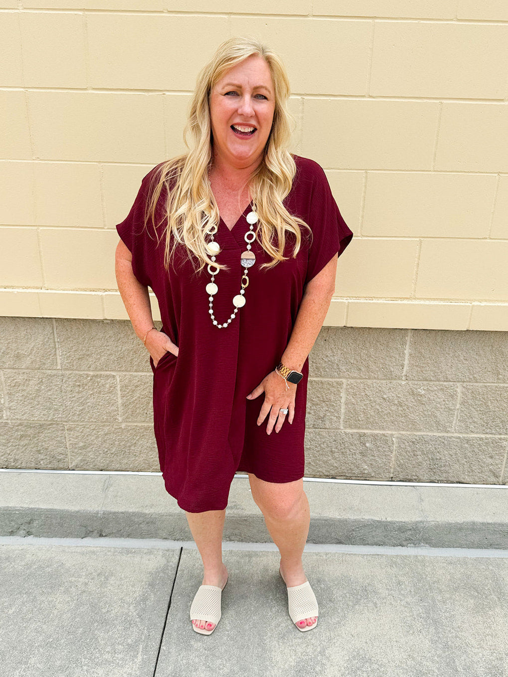 Garnet short sleeve mini dress with deep V-neck, drop shoulders, and side pockets—perfect for gameday.