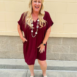 Garnet short sleeve mini dress with deep V-neck, drop shoulders, and side pockets—perfect for gameday.