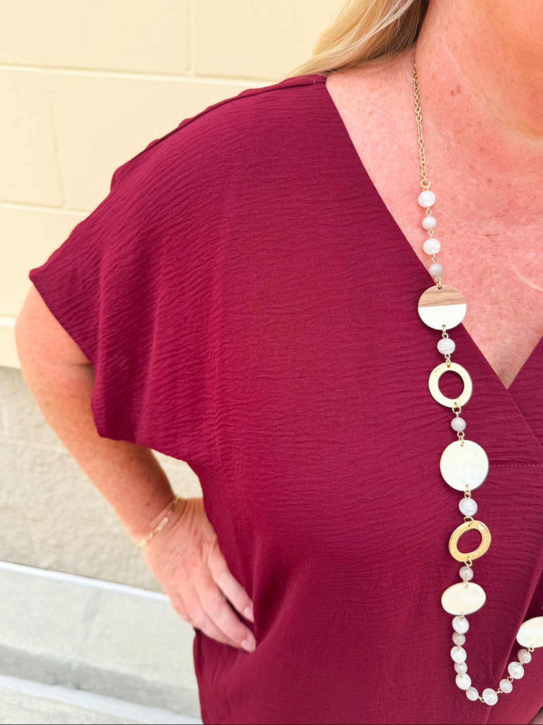 Garnet short sleeve mini dress with deep V-neck, drop shoulders, and side pockets—perfect for gameday.