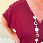 Garnet short sleeve mini dress with deep V-neck, drop shoulders, and side pockets—perfect for gameday.
