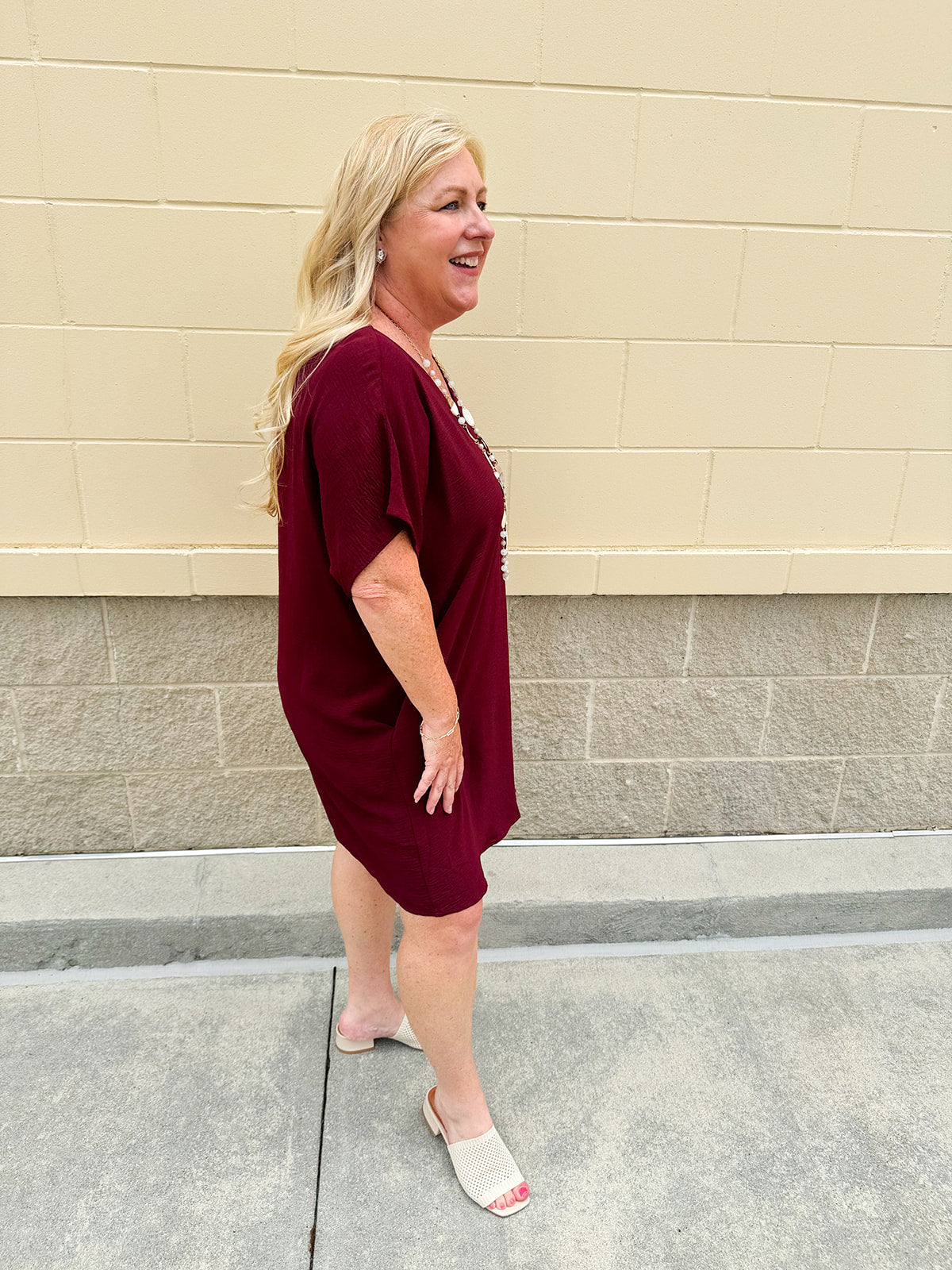 Garnet short sleeve mini dress with deep V-neck, drop shoulders, and side pockets—perfect for gameday.