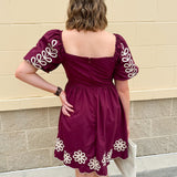 Garnet embroidered mini dress with puff sleeves, square neck, floral detailing, and scalloped hem—perfect for FSU gameday