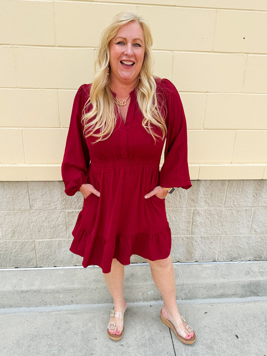 Garnet long sleeve woven mini dress with V-neckline, elastic waist, tiered hem, and pockets—lightweight and perfect for early fall wear