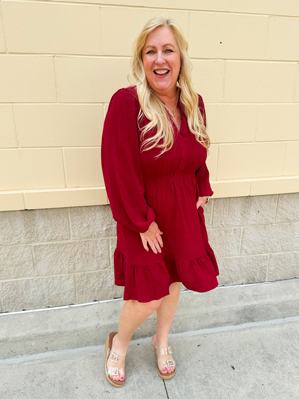Garnet long sleeve woven mini dress with V-neckline, elastic waist, tiered hem, and pockets—lightweight and perfect for early fall wear