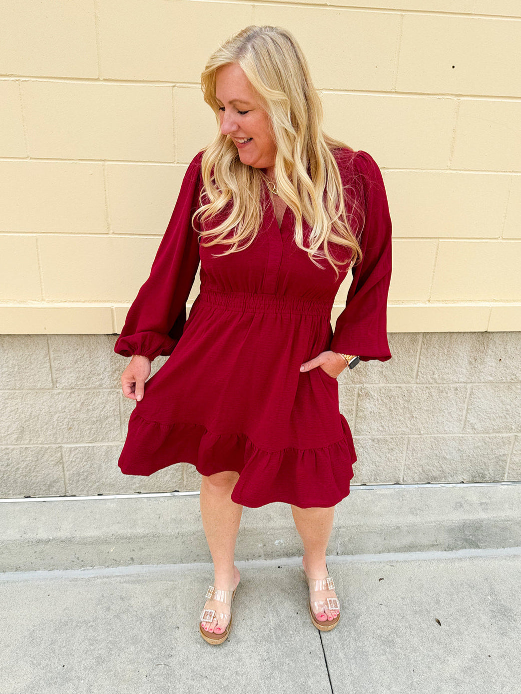 Garnet long sleeve woven mini dress with V-neckline, elastic waist, tiered hem, and pockets—lightweight and perfect for early fall wear