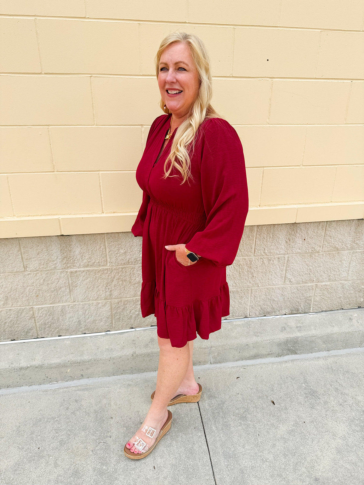 Garnet long sleeve woven mini dress with V-neckline, elastic waist, tiered hem, and pockets—lightweight and perfect for early fall wear