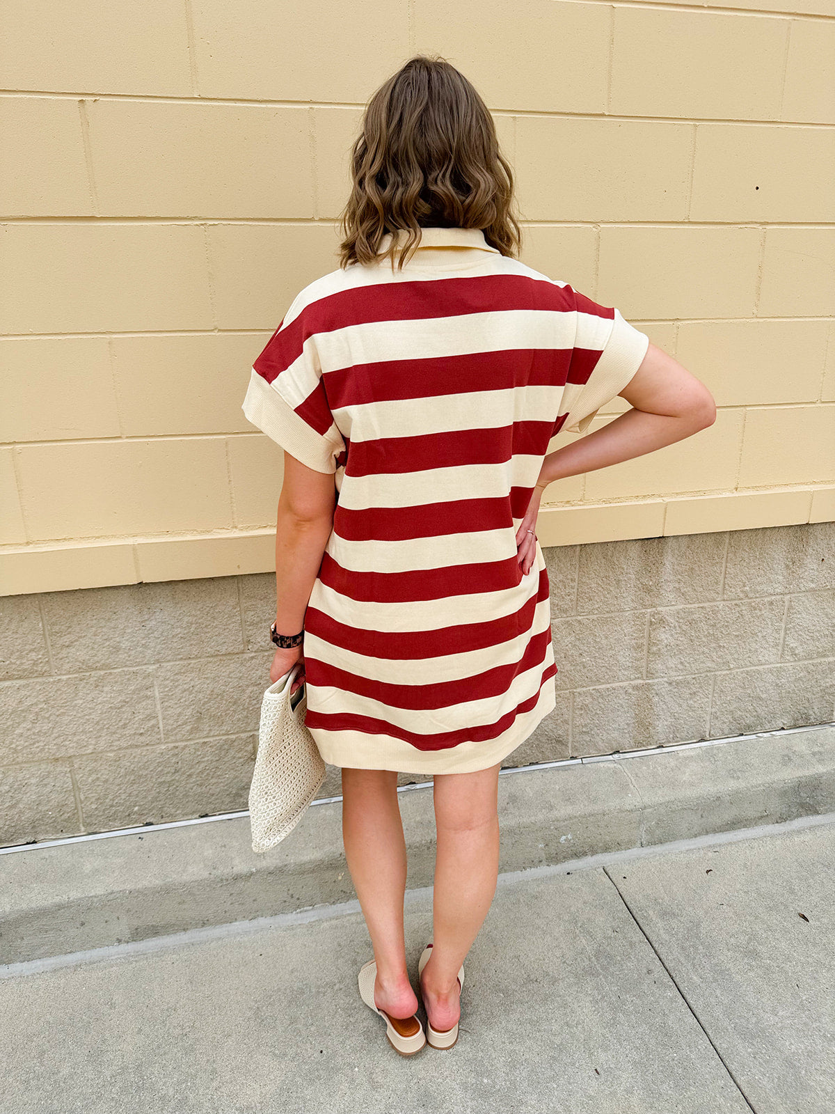 Mini dress with a zippered split-neck collar, cuffed sleeves, and colorblock-style stripes—sporty, stylish, and perfect for Gameday wear.