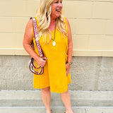 Sleeveless mustard cotton gauze dress with V-neckline, raw frayed edges, and front pockets. Lightweight and casual—ideal for Gameday or fall outings.
