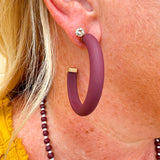 Gold-framed earrings with bold garnet centers available in small, medium, and large sizes—perfect for Gameday or holiday style.