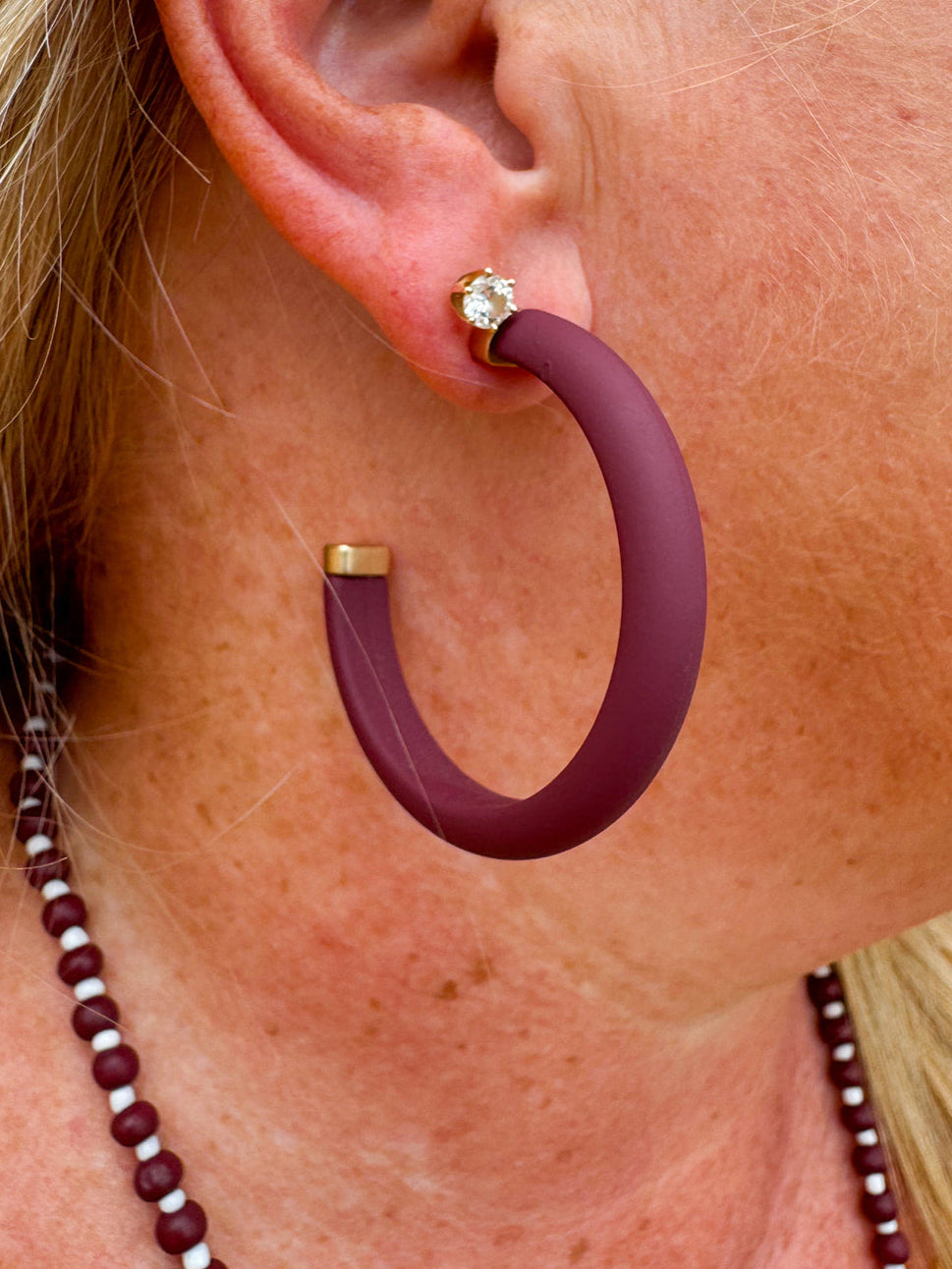 Gold-framed earrings with bold garnet centers available in small, medium, and large sizes—perfect for Gameday or holiday style.