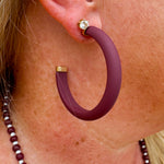 Gold-framed earrings with bold garnet centers available in small, medium, and large sizes—perfect for Gameday or holiday style.