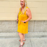 Sleeveless mustard cotton gauze dress with V-neckline, raw frayed edges, and front pockets. Lightweight and casual—ideal for Gameday or fall outings.