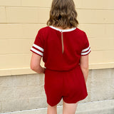 Garnet knit romper with white contrast trim on neckline, sleeves, and chest pocket. Features half sleeves, elastic waist, and keyhole back—sporty and stylish.