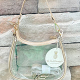 Clear stadium-approved crossbody purse with gold hardware and two strap options, perfect for game days or concerts.