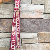 Garnet and gold printed purse strap with FSU and Go Noles lettering, reversible design with brass hardware.