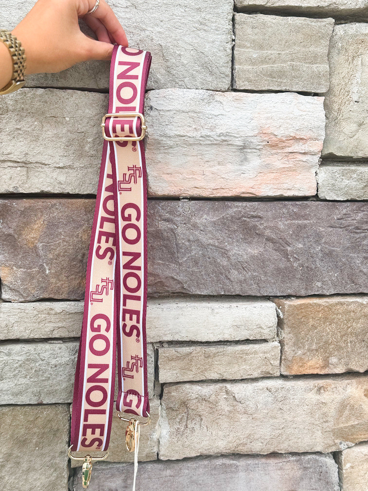 Garnet and gold printed purse strap with FSU and Go Noles lettering, reversible design with brass hardware.