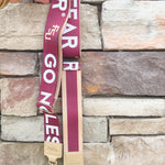 Reversible garnet and gold FSU purse strap with "Fear the Spear" and "Go Noles" text, adjustable with brass hardware.