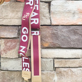 Reversible garnet and gold FSU purse strap with "Fear the Spear" and "Go Noles" text, adjustable with brass hardware.