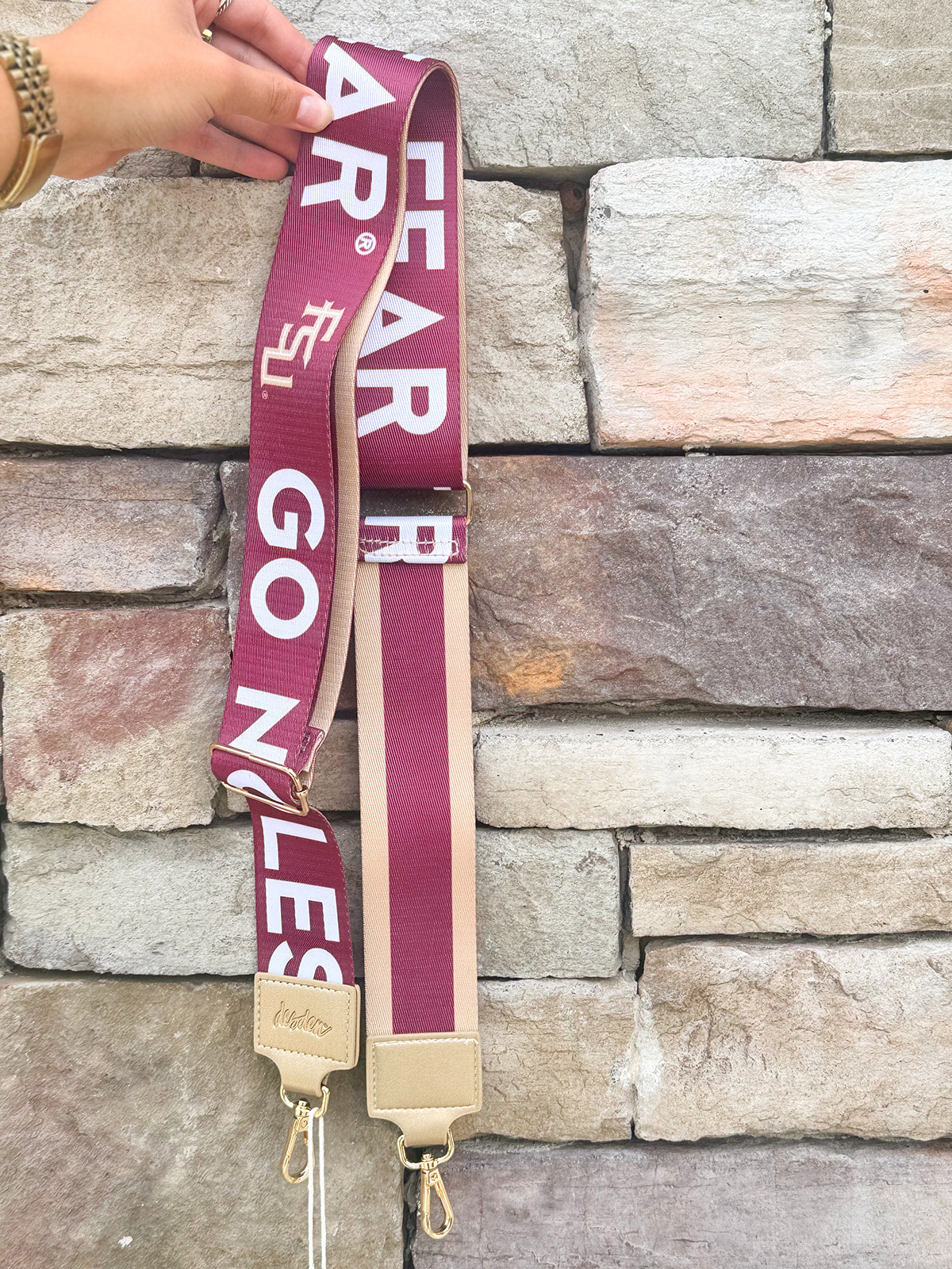 Reversible garnet and gold FSU purse strap with "Fear the Spear" and "Go Noles" text, adjustable with brass hardware.