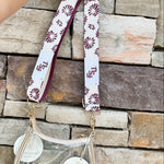 Reversible garnet and gold FSU bag strap with floral print and stripes, featuring brass hardware.