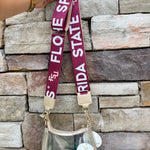 Reversible garnet and gold FSU purse strap with "Fear the Spear" and "Go Noles" text, adjustable with brass hardware.