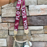 Reversible garnet and gold FSU purse strap with "Fear the Spear" and "Go Noles" text, adjustable with brass hardware.