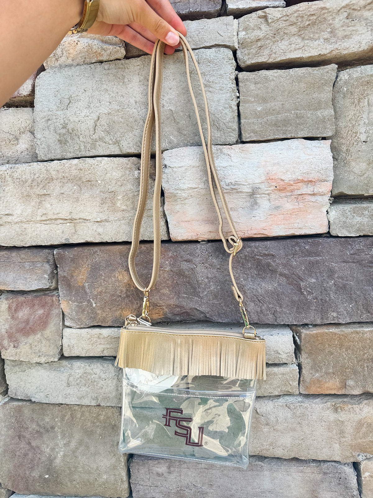 Clear crossbody purse with gold vegan leather, fringe trim, and FSU logo, designed for stadium approval and style.