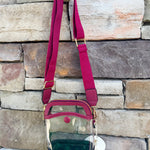 Garnet-trimmed clear stadium bag with zipper closure, top handle, and adjustable crossbody strap.