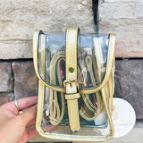 Clear crossbody bag with gold faux leather trim and belt buckle accent, perfect for stadium entry.