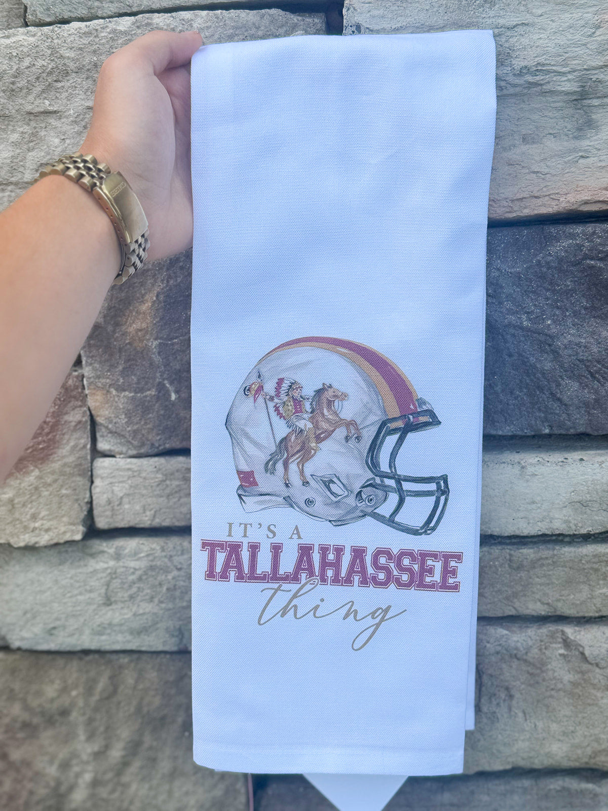 White cotton kitchen towel with painted football helmet featuring Osceola and Renegade, no border or edging.