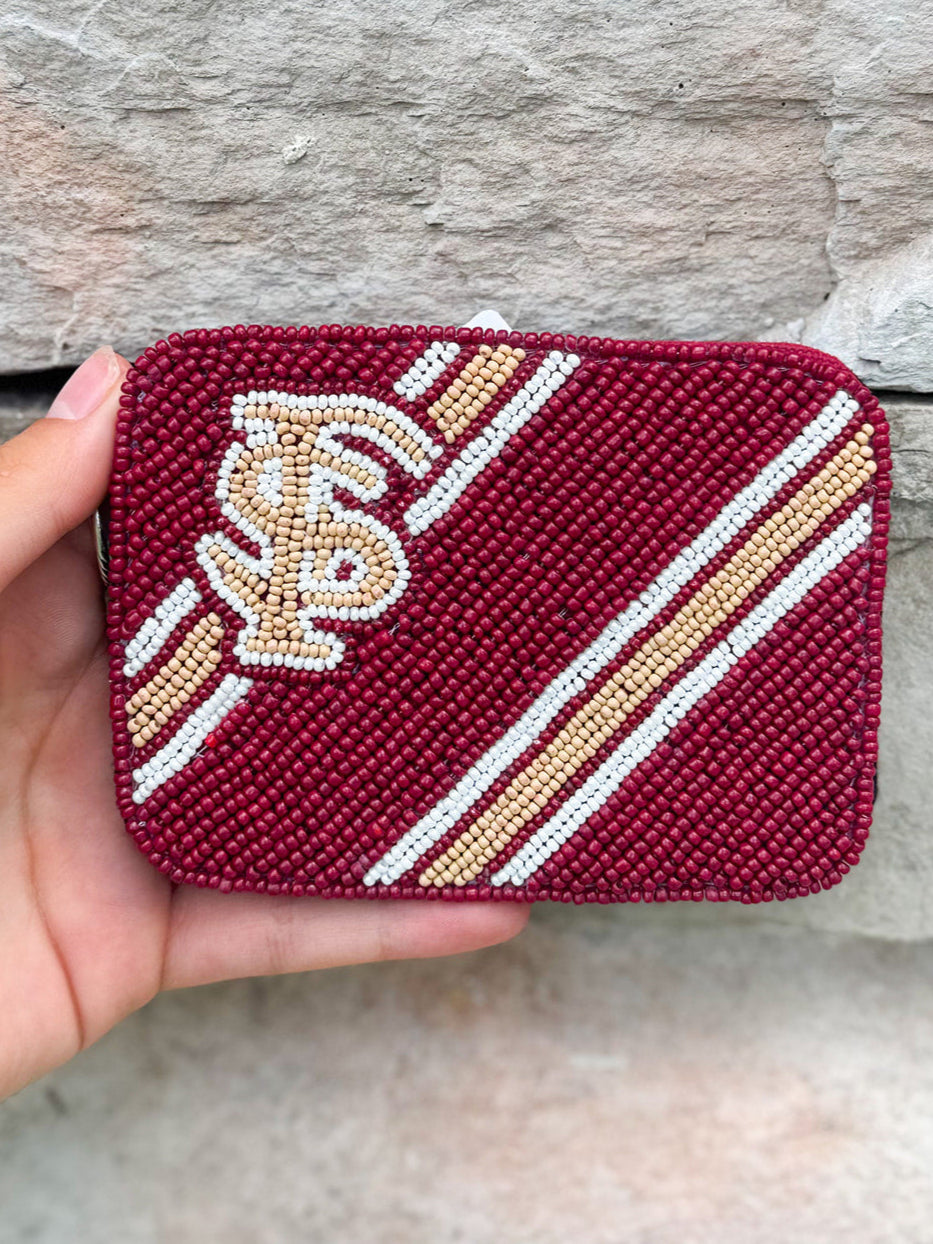 A burgundy beaded credit card holder with the Florida State Seminoles logo in the center.