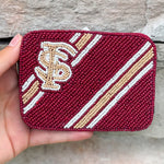 A burgundy beaded credit card holder with the Florida State Seminoles logo in the center.