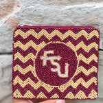 Maroon and gold chevron patterned pouch with 'FSU' logo held against a stone background