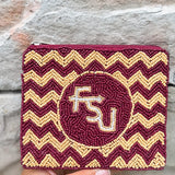 Maroon and gold chevron patterned pouch with 'FSU' logo held against a stone background