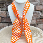 Orange and white Tennessee Volunteers magnetic pearl scarf necklace with silky checkerboard scarf and magnetic pearl clasp.