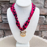Red and black patterned scarf necklace with a gold-tone Georgia Bulldogs mascot charm.